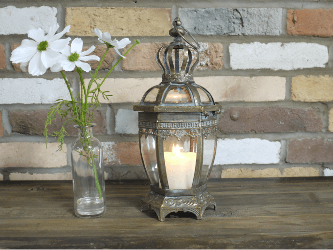 Small bronze ornate lantern with crown top and ring for hanging.