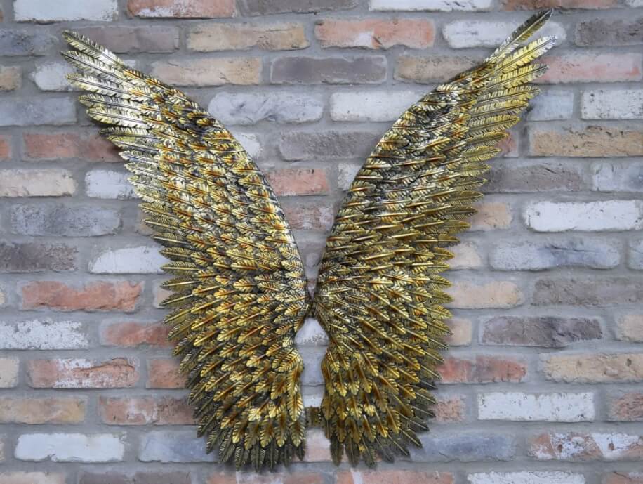 Gold metal wall mounted angel wings. Feather texture.